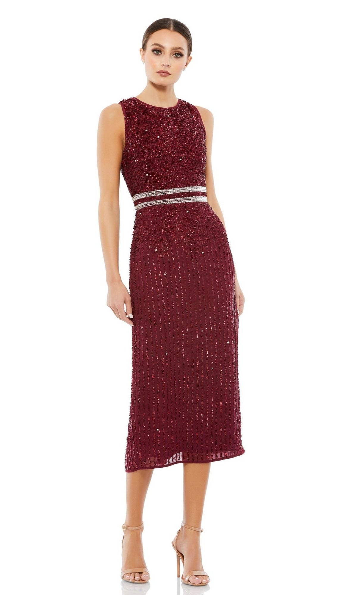 A woman wears the Mac Duggal 10509 Short Sequin Wedding Guest Dress—sleeveless, knee-length, burgundy with two silver waist bands—paired with strappy high-heeled sandals.